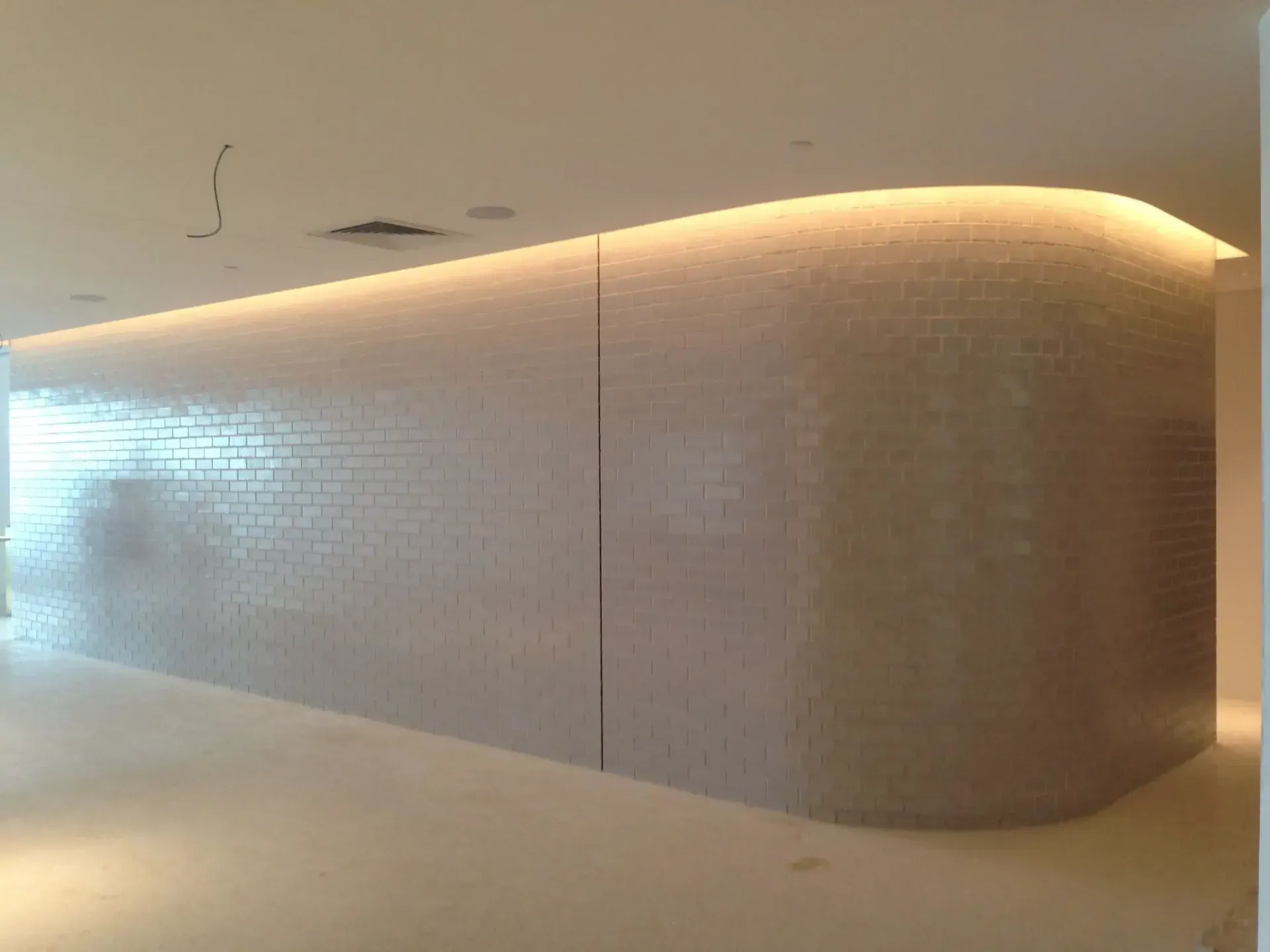 A Curved Wall In A Building With A Light On It — Mascrete Pty Ltd In Hermit Park, QLD