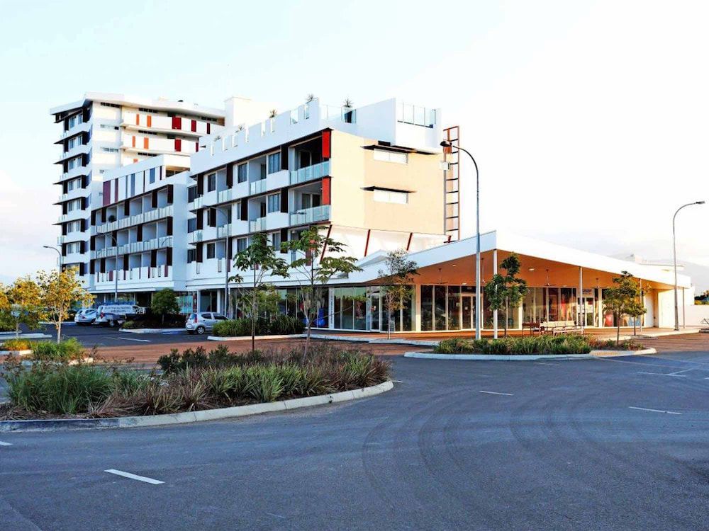 A Large Building With A Lot Of Windows Is Next To A Parking Lot — Mascrete Pty Ltd In Hermit Park, QLD