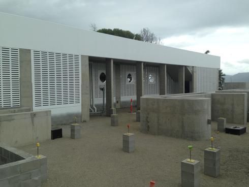A White Building With A Lot Of Concrete Blocks In Front Of It — Mascrete Pty Ltd In Hermit Park, QLD