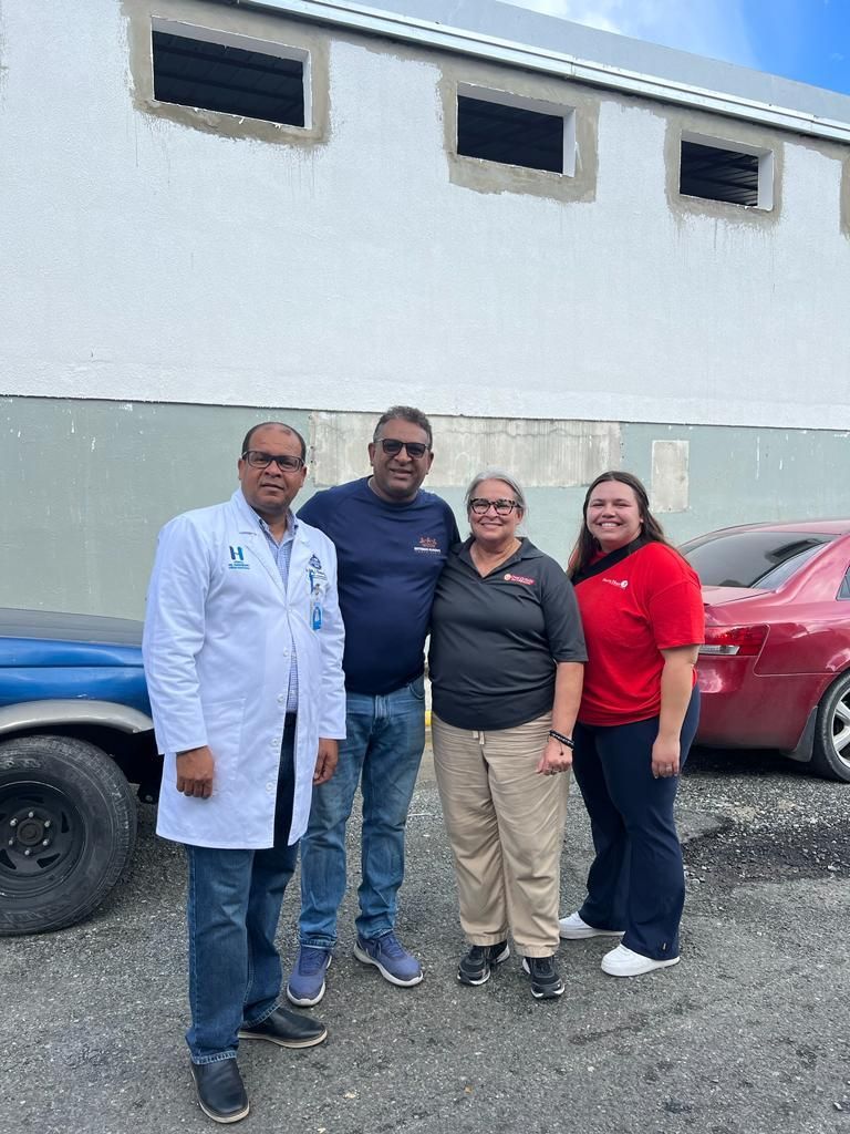 A group of people are posing for a picture in front of a building.