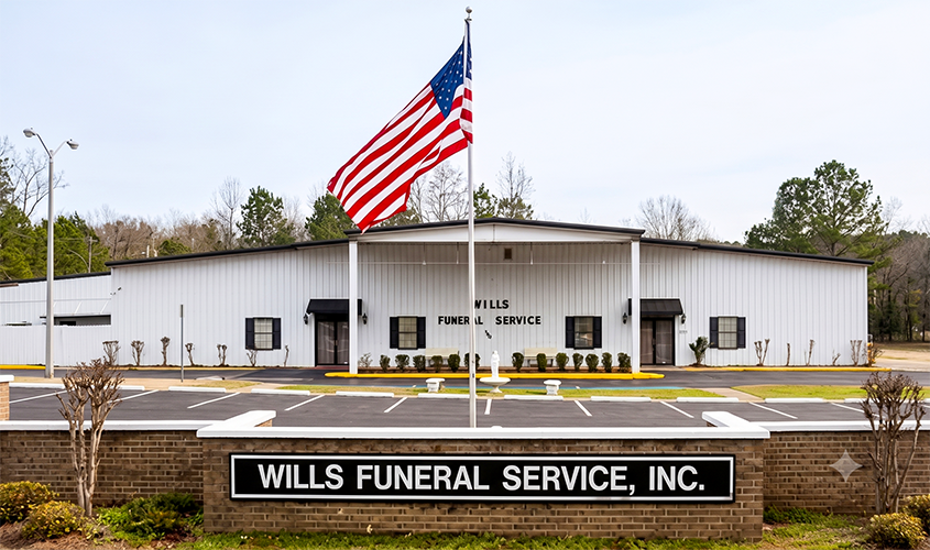 Wills Funeral Service, Inc. building with a large American flag in front