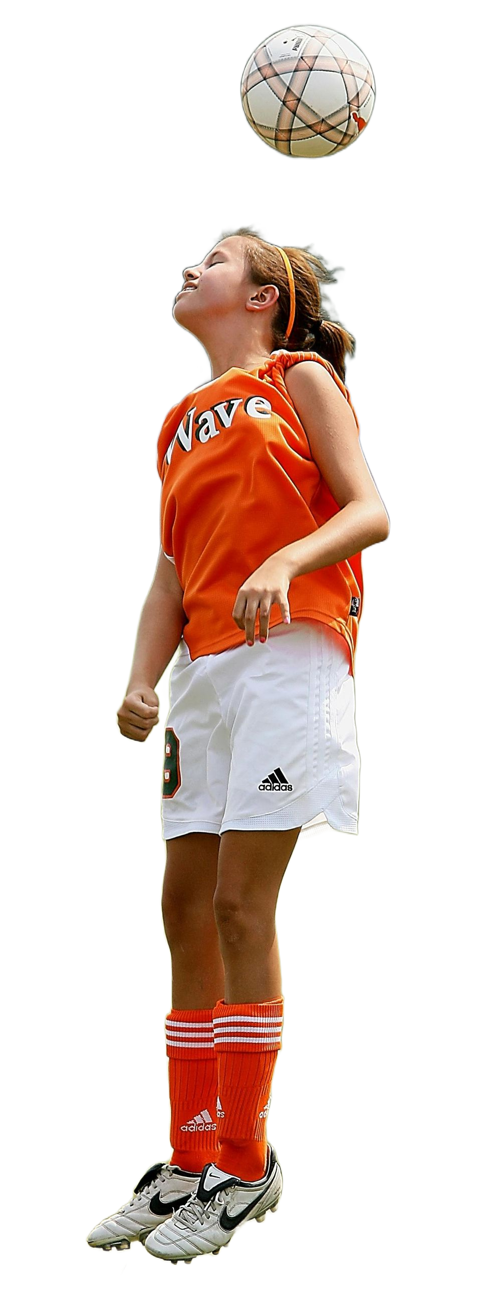 A person in an orange jersey and white shorts heads a soccer ball.