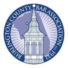 The logo for burlington county bar association is a purple circle with a tower in the middle.