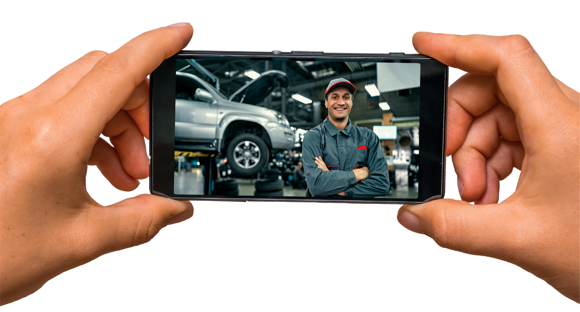 A person is holding a cell phone with a picture of a mechanic on the screen.