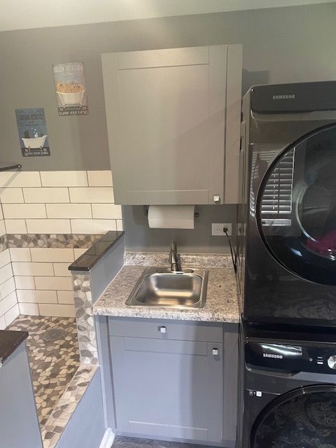 A kitchen is being remodeled with white cabinets and a yellow level.