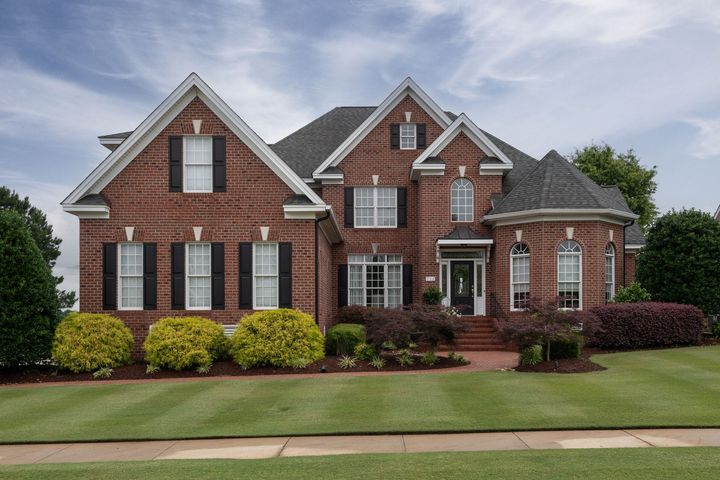 House with a Sold sign  in the front yard