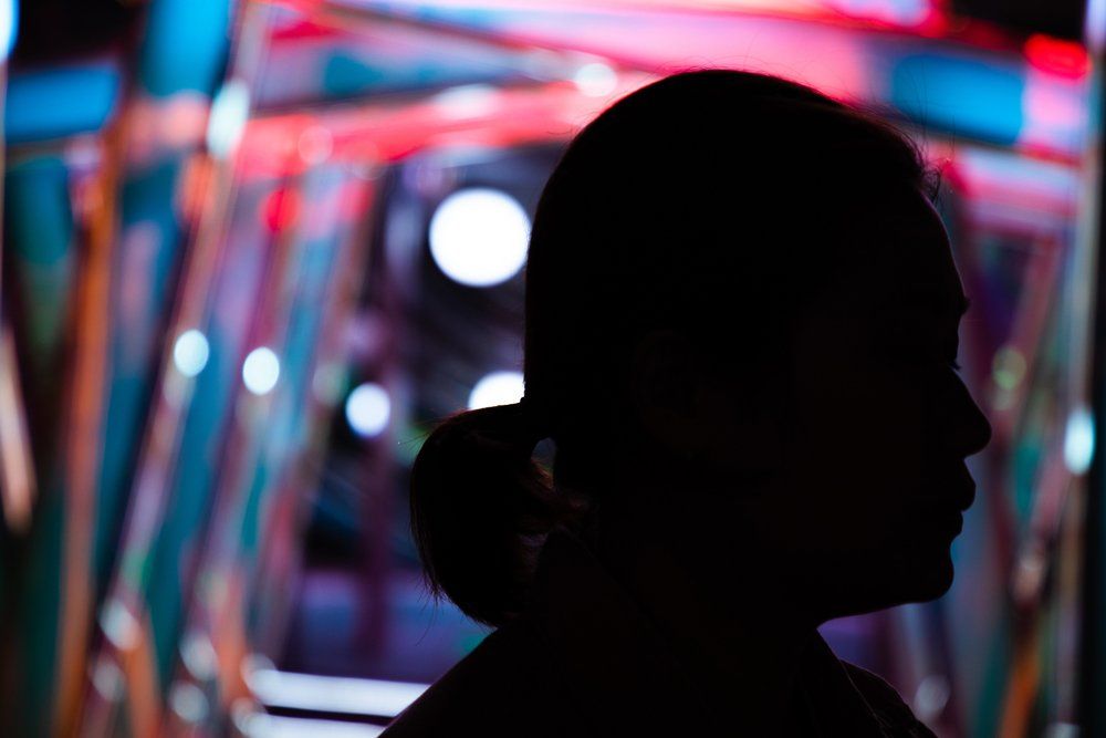 Woman in Silhouette Against Neon Light — North Port, FL — A-1 Fingerprinting and Drug Screening