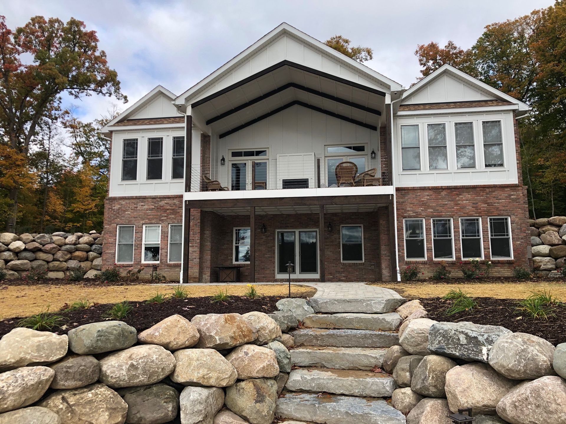 A large brick house with stairs leading up to it