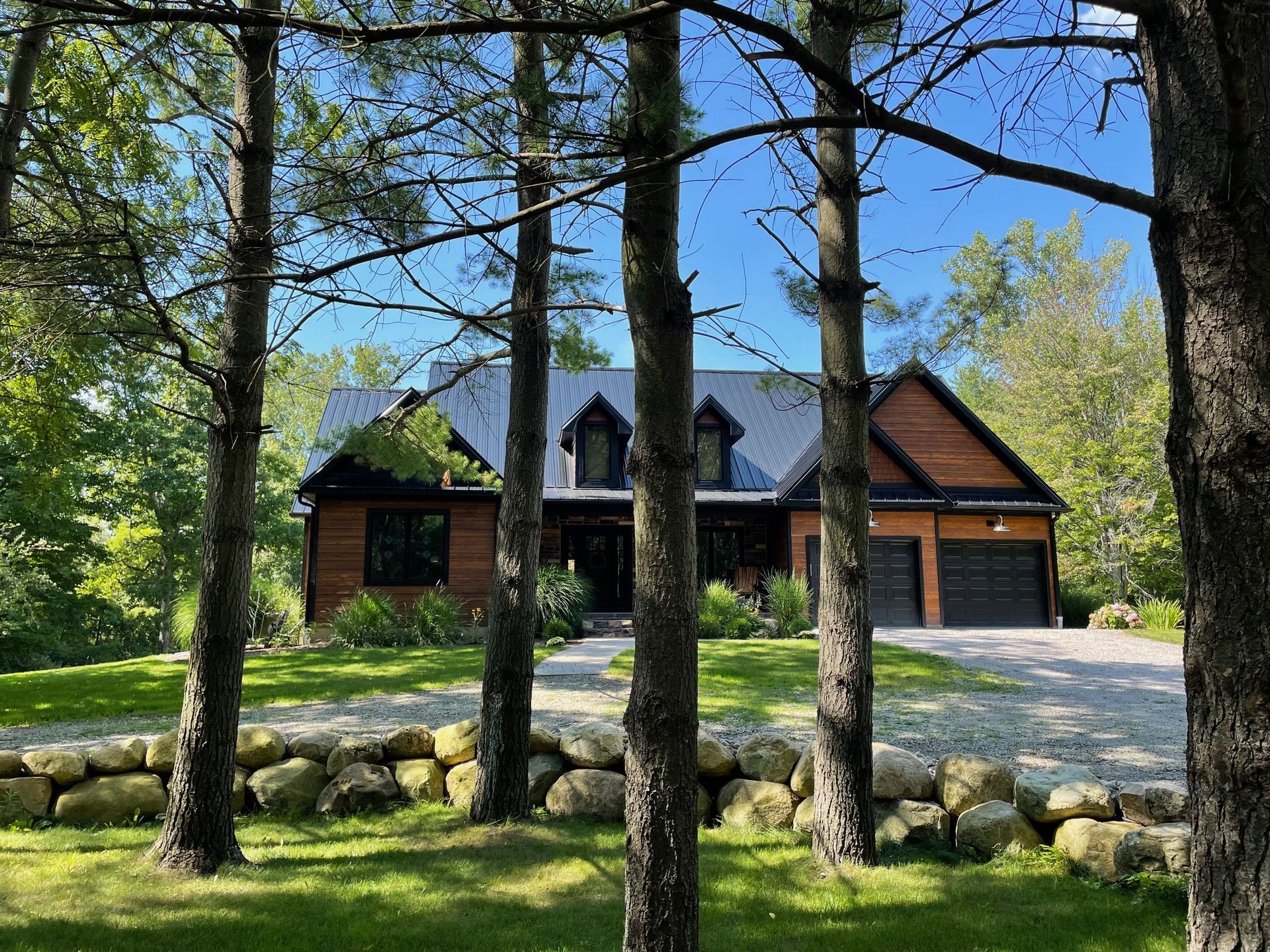 A house is surrounded by trees on a sunny day