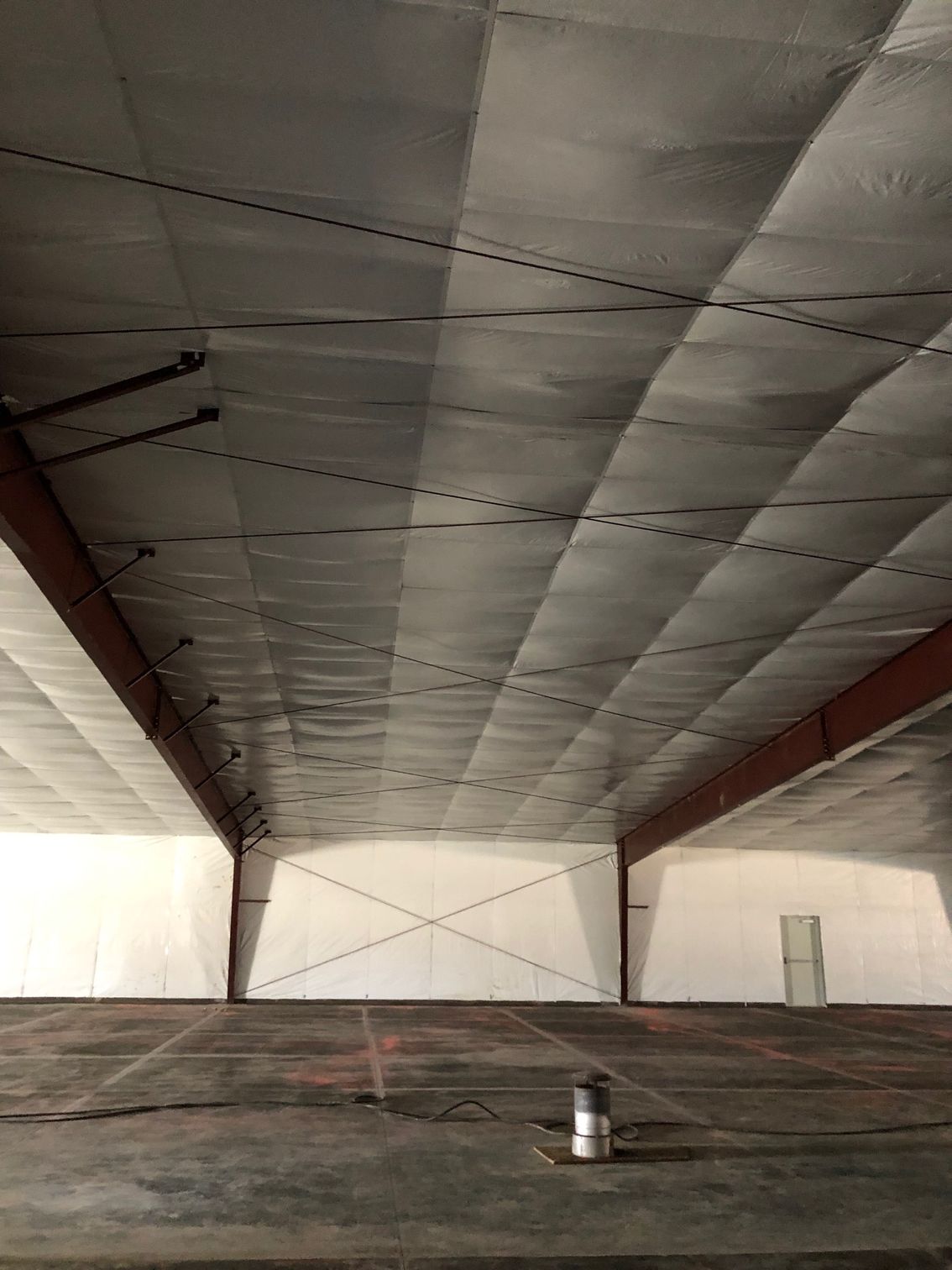 The ceiling of a building with a lot of insulation on it.