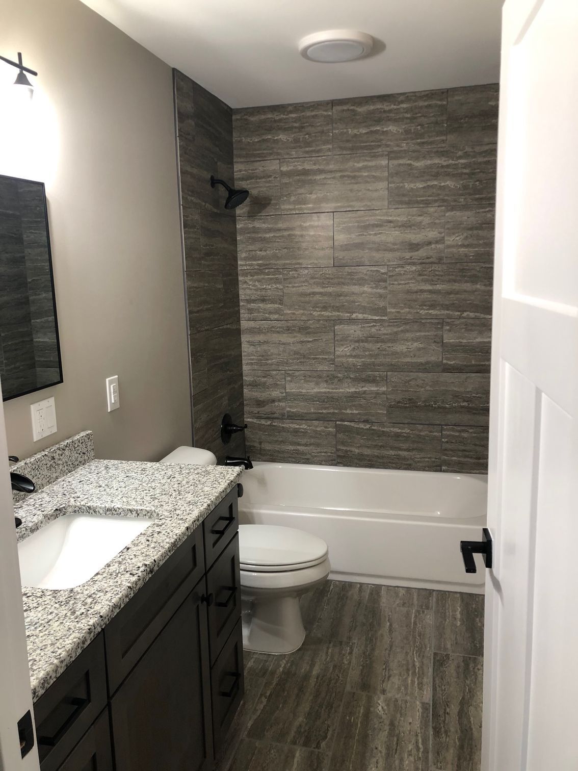 A bathroom with a sink , toilet , tub and shower.