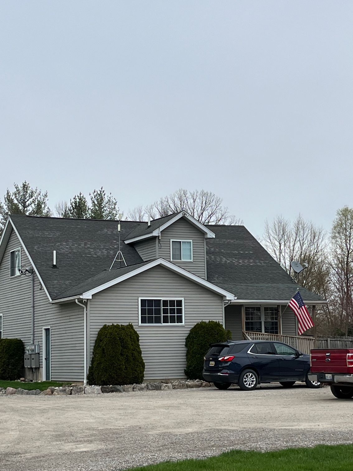 A house with a red truck parked in front of it.