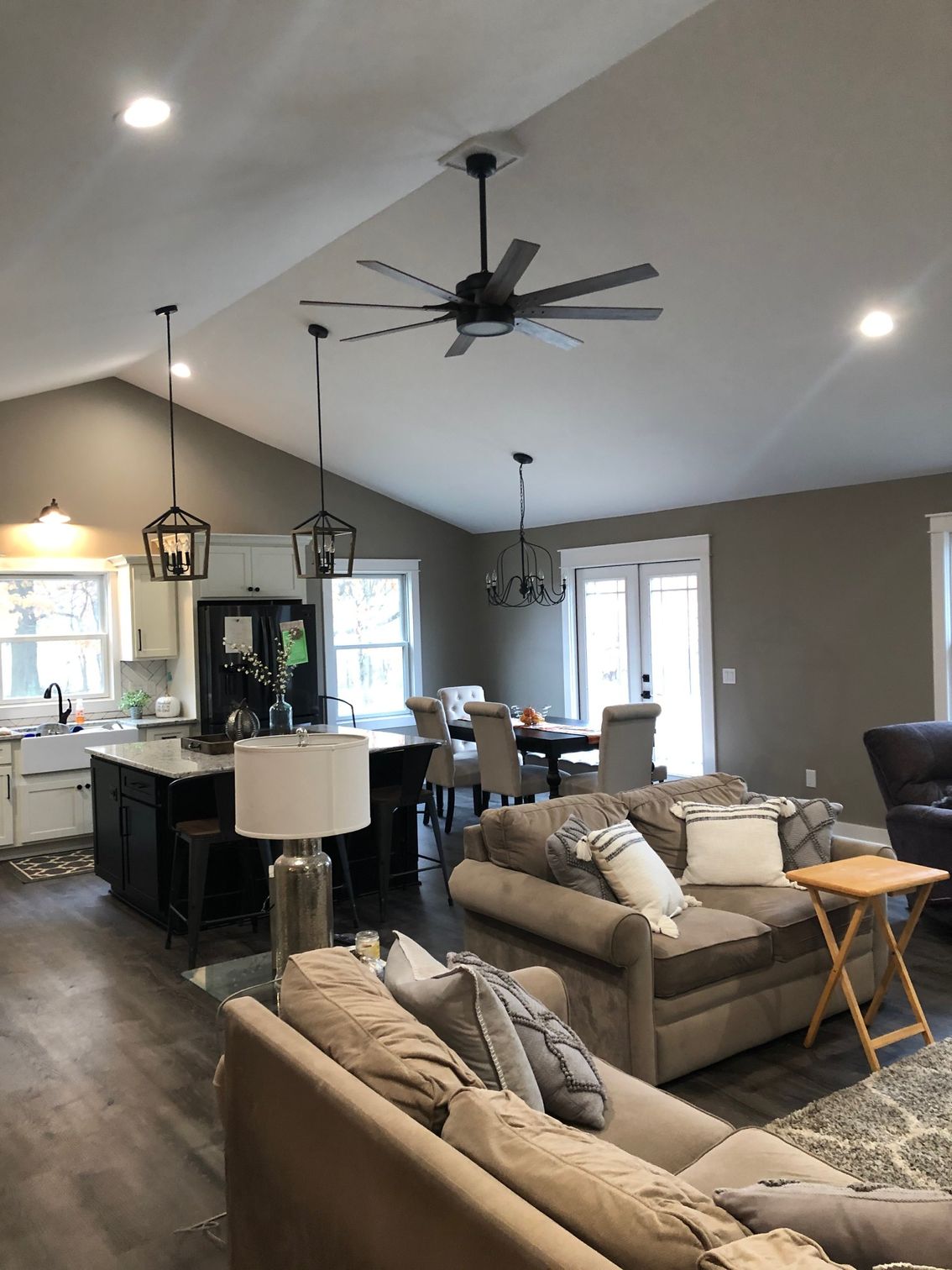 A living room filled with furniture and a ceiling fan