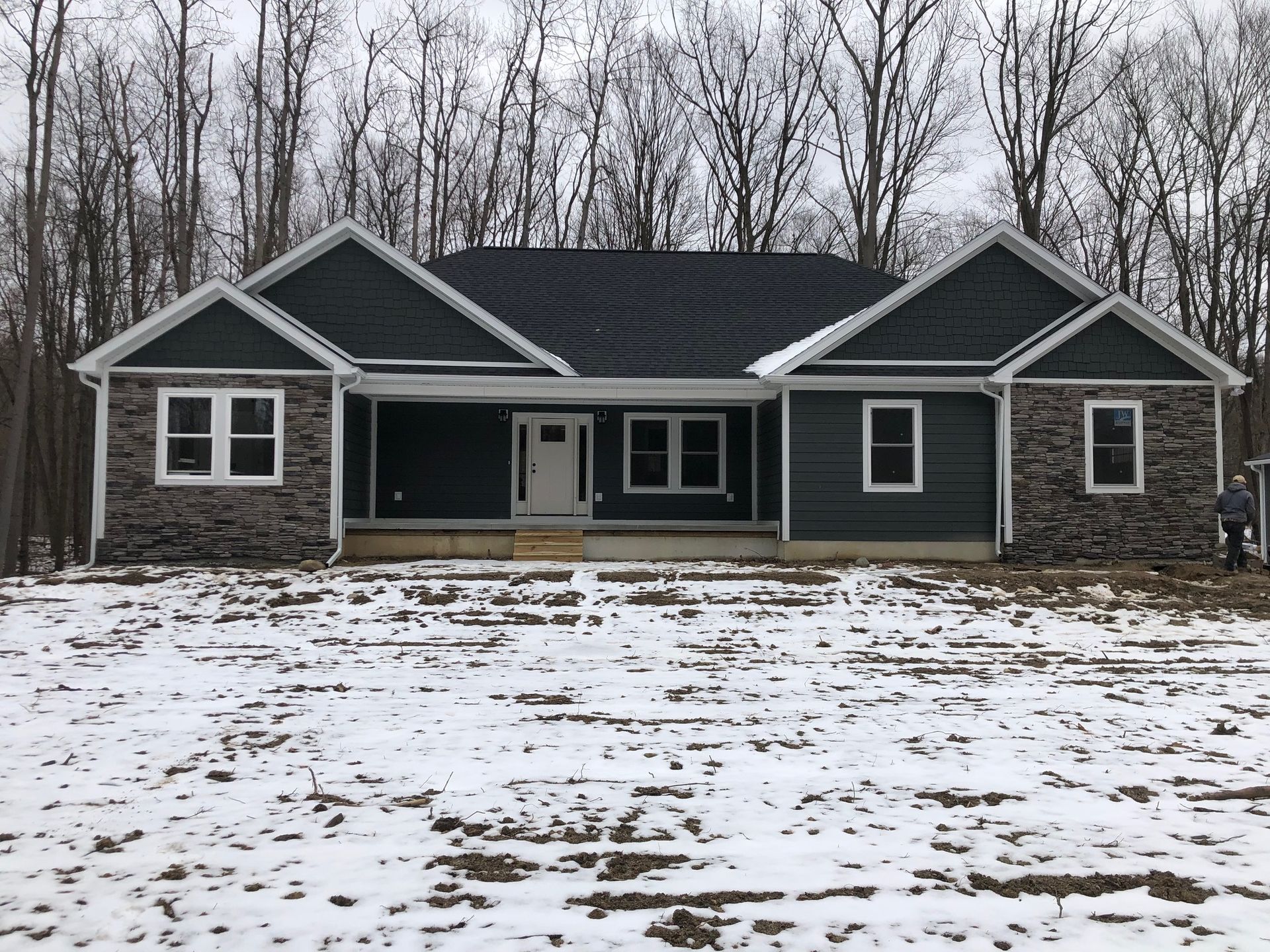 A house is sitting in the middle of a snowy field
