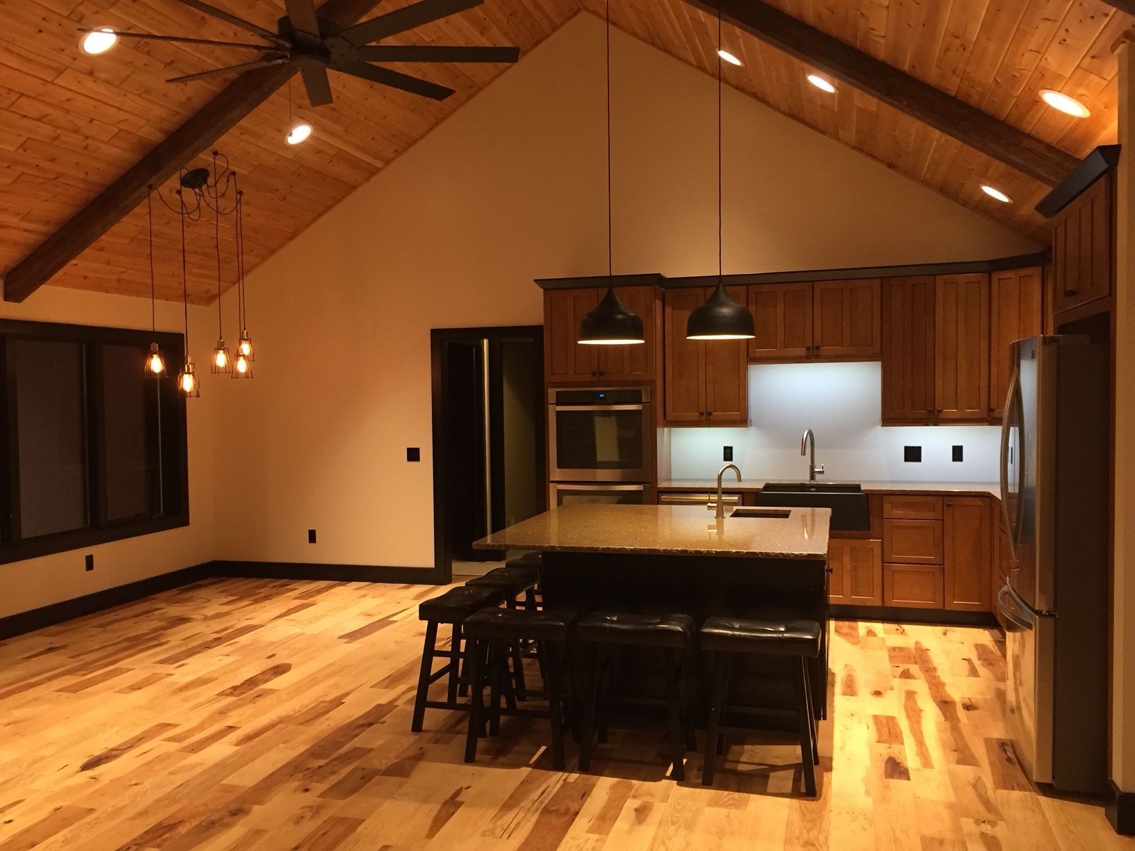 A kitchen with a vaulted ceiling and wooden cabinets