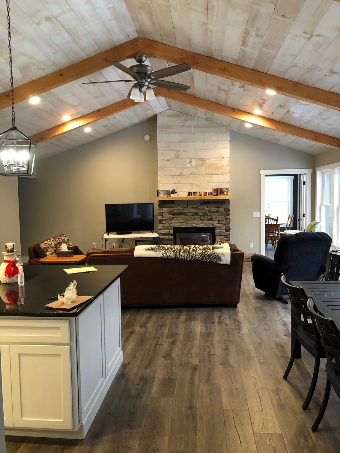 A living room with a ceiling fan and a fireplace