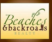 A living room with a couch , chairs , ottoman and a mirror