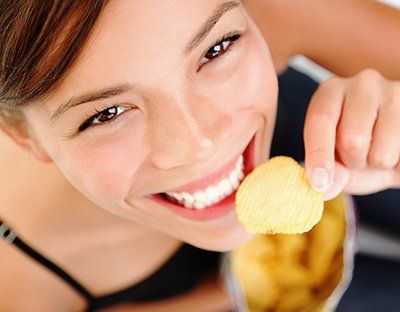 Lady eating potato chip