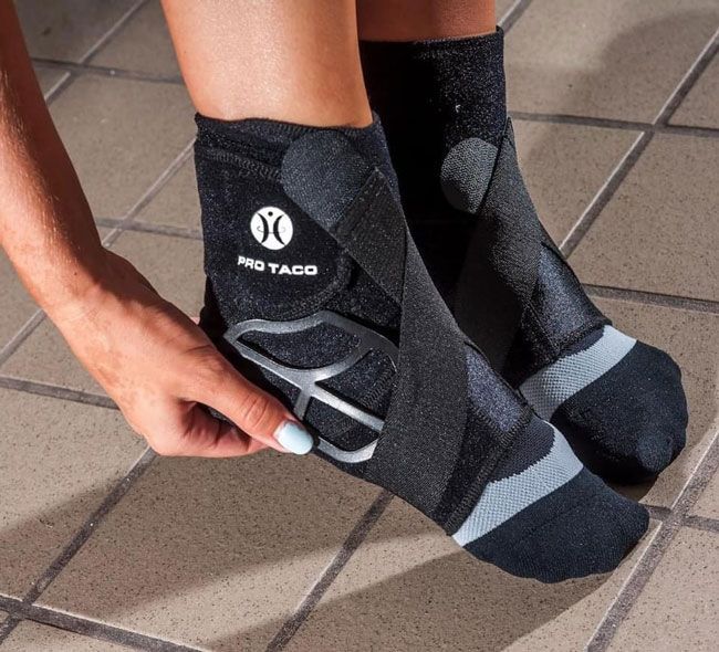 A person wearing a pair of protaco ankle braces