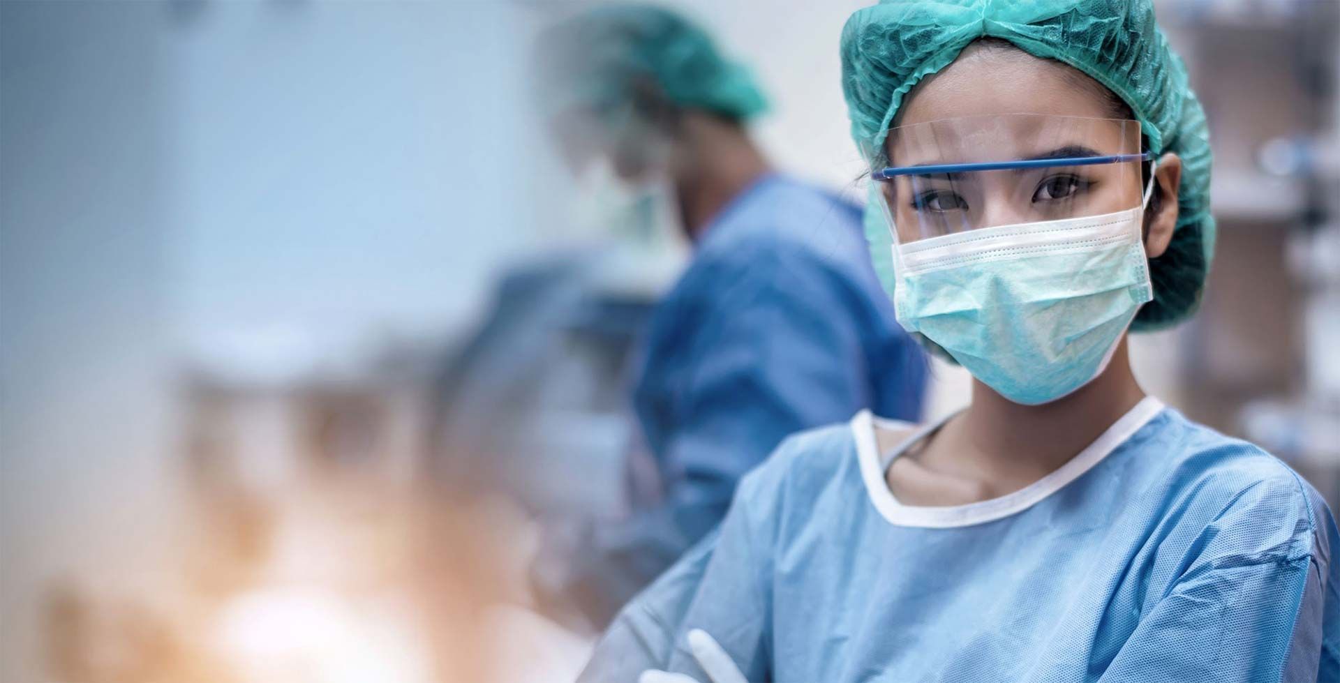 A stethoscope is sitting on top of a clipboard next to a laptop.