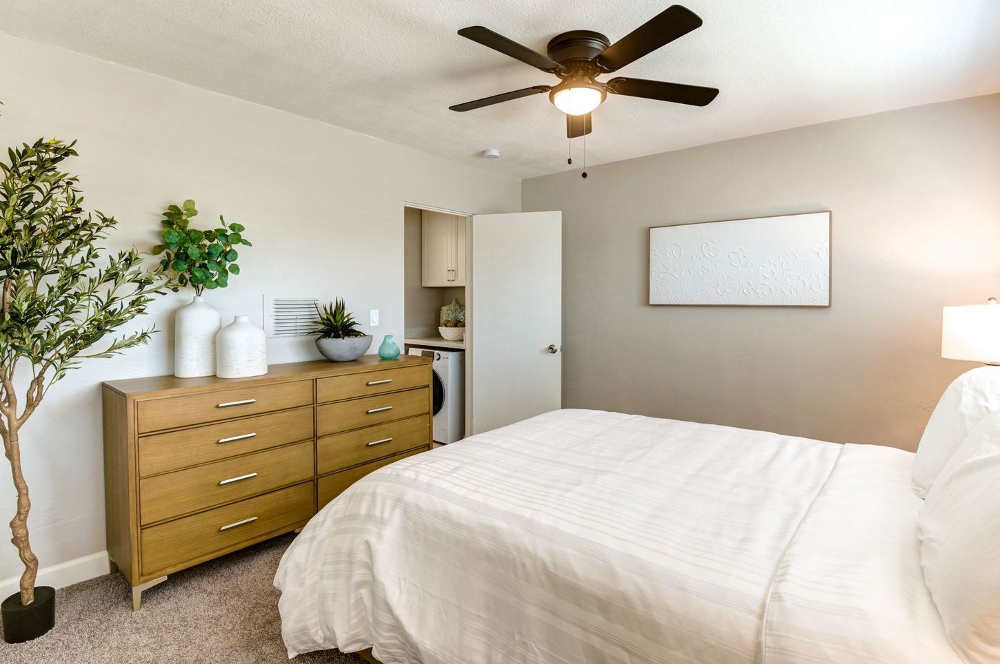 photo showing a bed in a bedroom with a ceiling fan