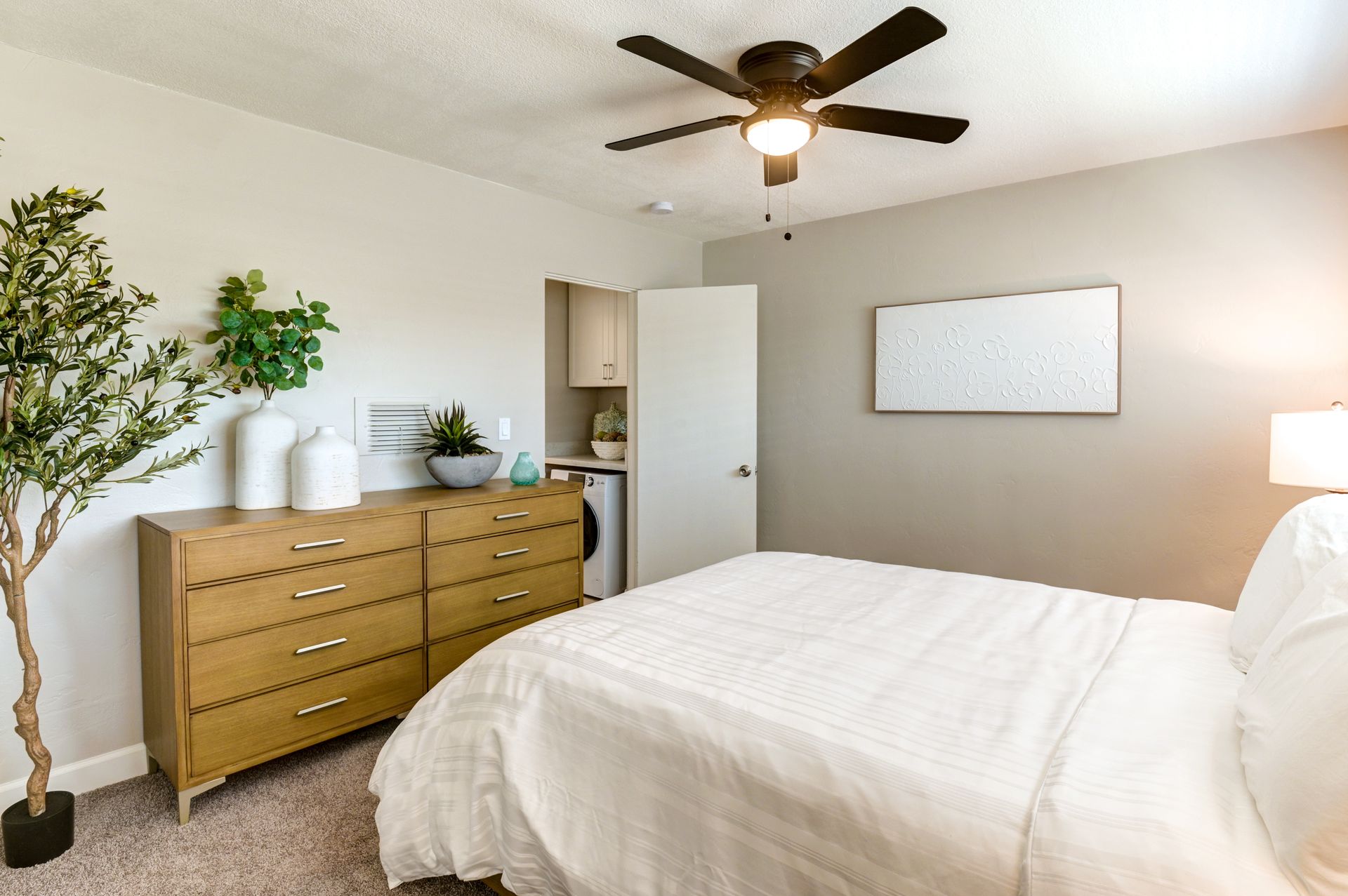 photo showing a bed in a bedroom with a ceiling fan