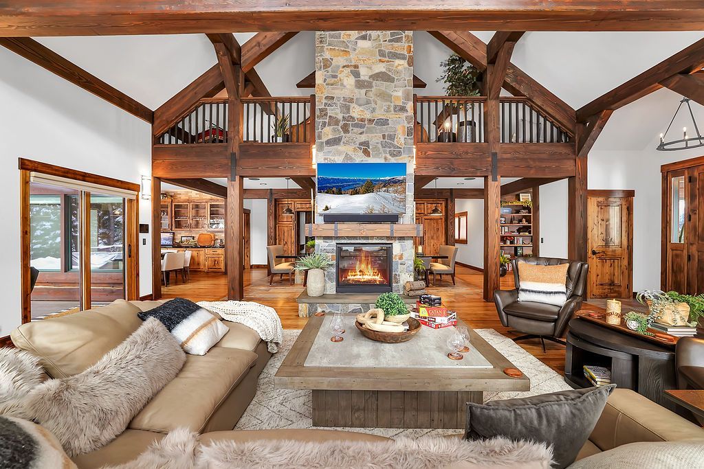 A living room with a couch , chair , table and rug.