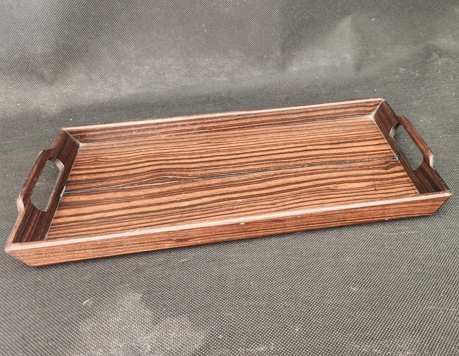 Ebony tray with smooth black and brown finish.