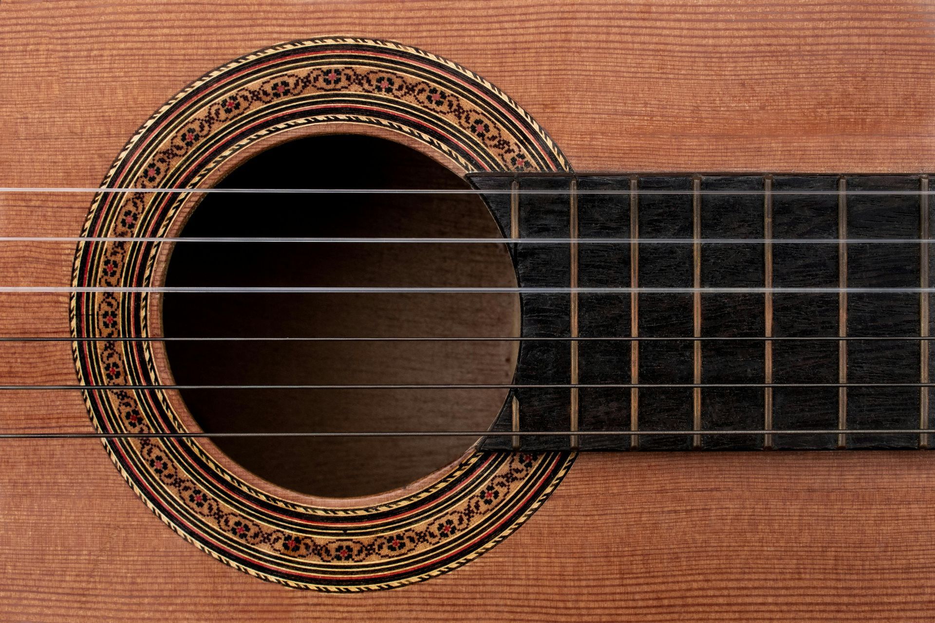a close up of a guitar with ebony parts