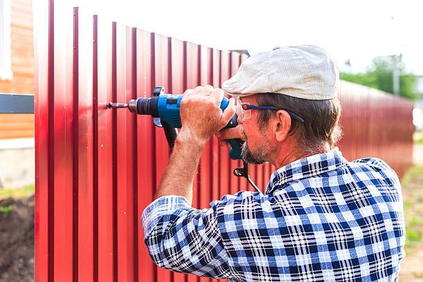 Installing a metal fence with heavy tools