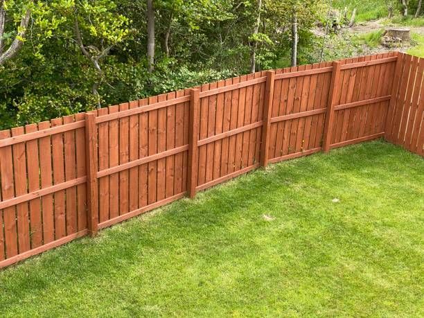 Wooden garden fence coated with medium oak color paint