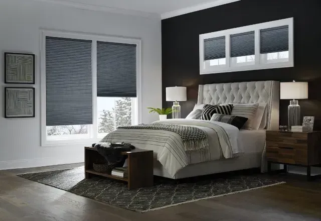 A bedroom with a bed , nightstand , and window shades. Love is Blinds North Carolina