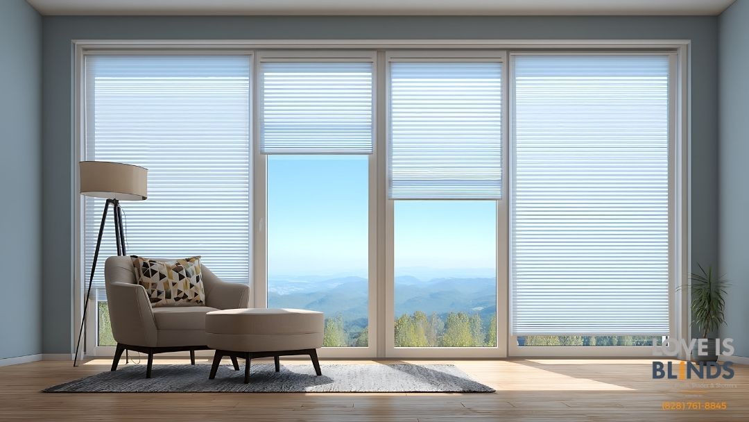 Living room with large windows, white blinds, a chair, and a lamp.  View of mountains through the open window.