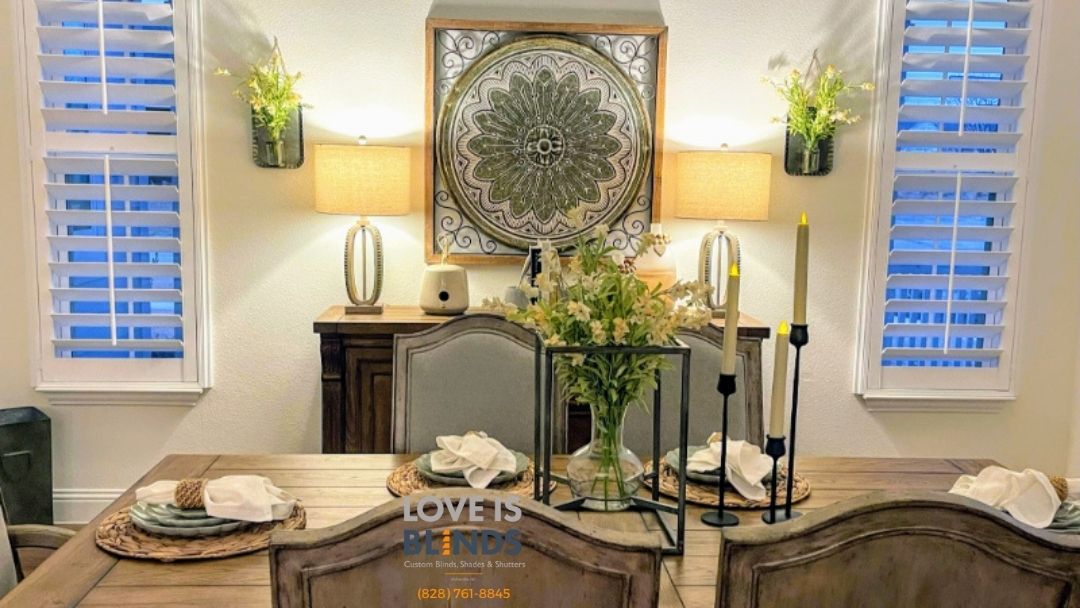 Formal dining room with wooden table set for a meal, shutters, and decorative wall art.