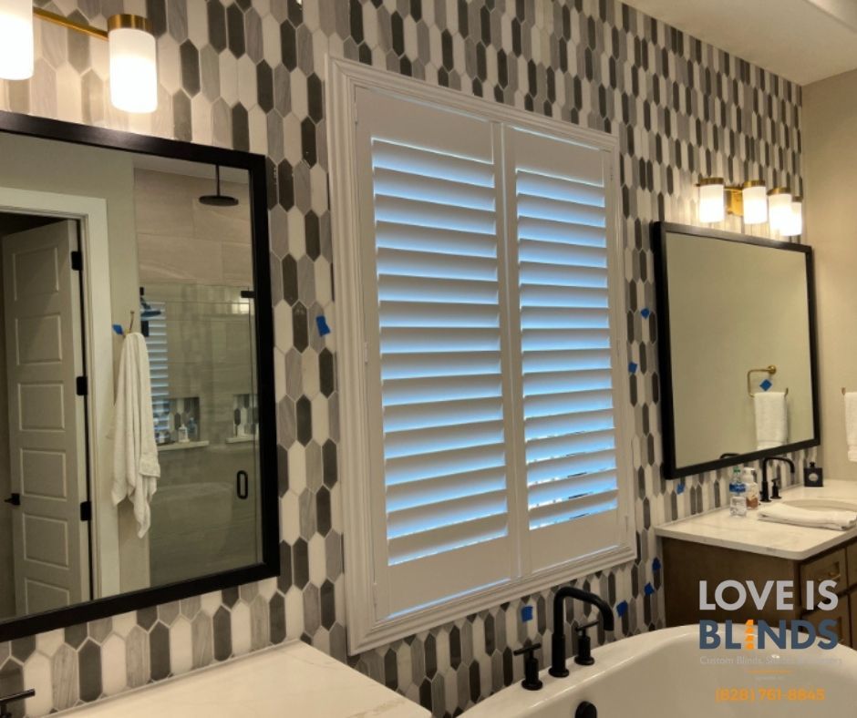 Bathroom with geometric tiled wall, shutters, and vanity with black fixtures.