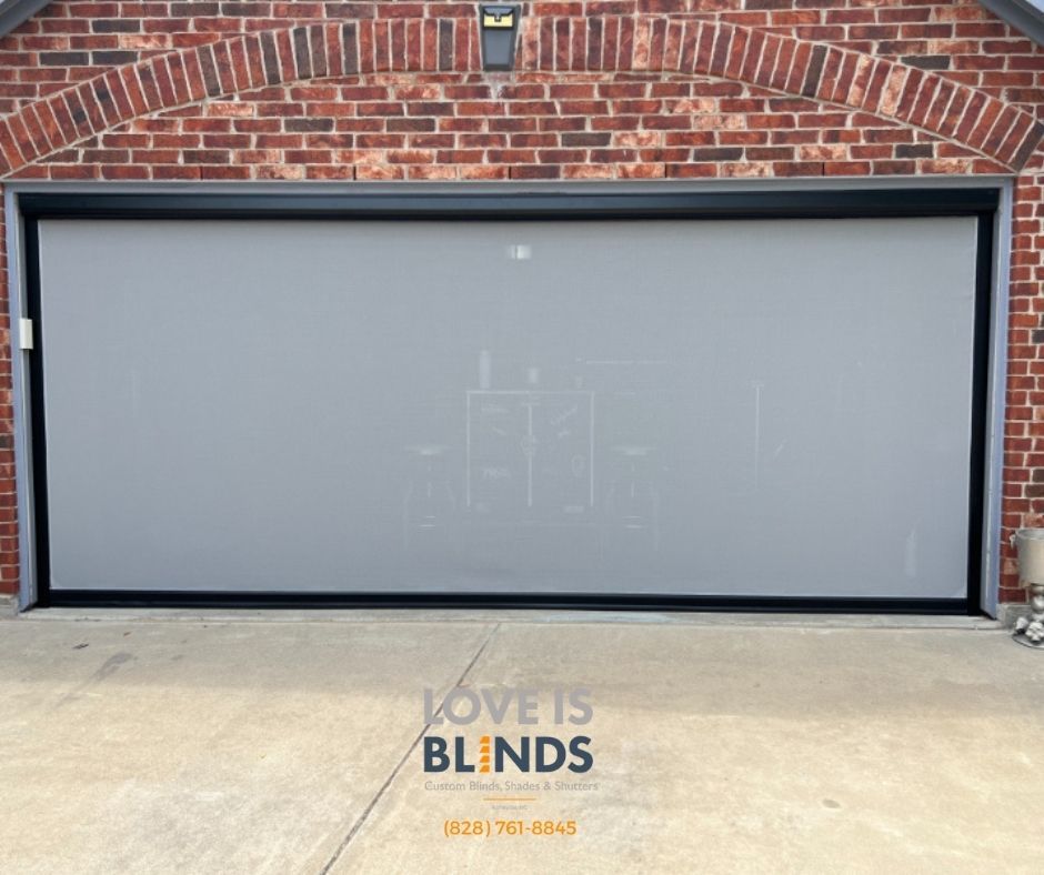 Gray garage screen, protecting from sun and pests, installed in brick garage.