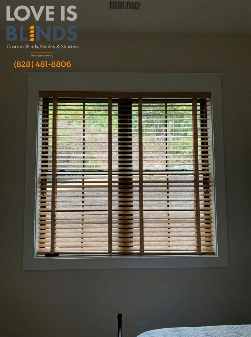 Wooden blinds on a window, inside a room. Natural light visible through the blinds.