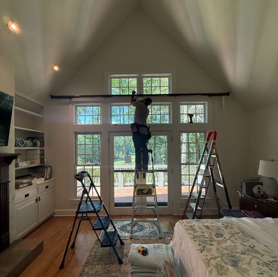 Matt from Love is Blinds is on a ladder installing custom shutters. 