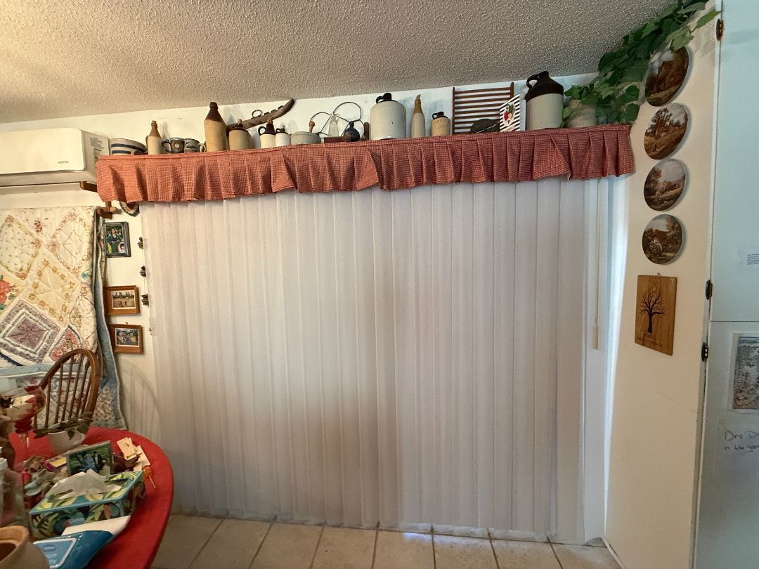 A living room with a couch , table and chairs and a kitchen. Love is Blinds Arizona (844) 936-2446