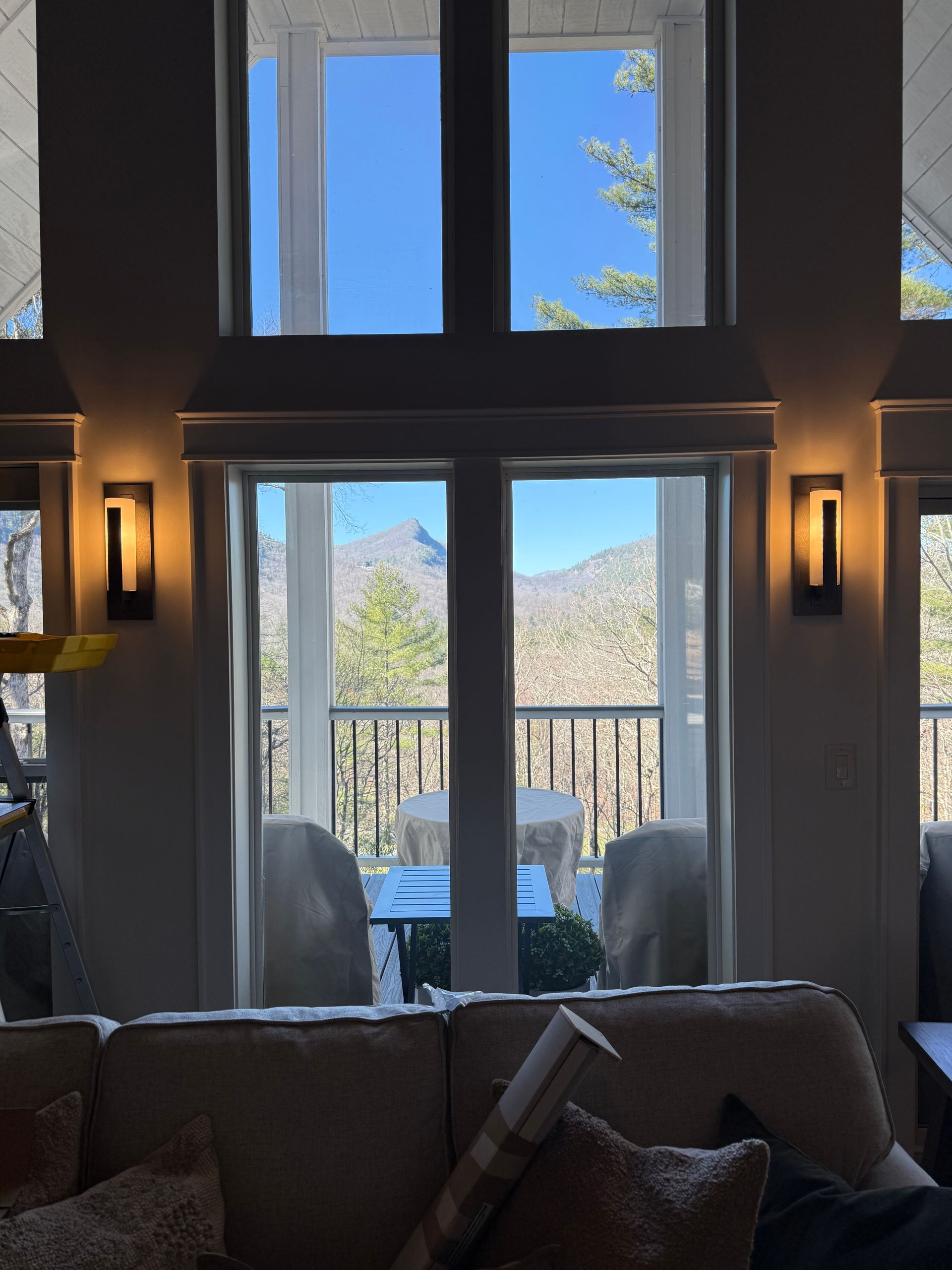 Before: bare double French doors with mountain view and no window treatments in Sapphire NC mountain home