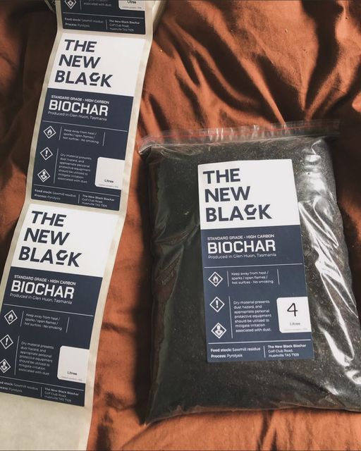 Two bags of the new black biochar on a bed