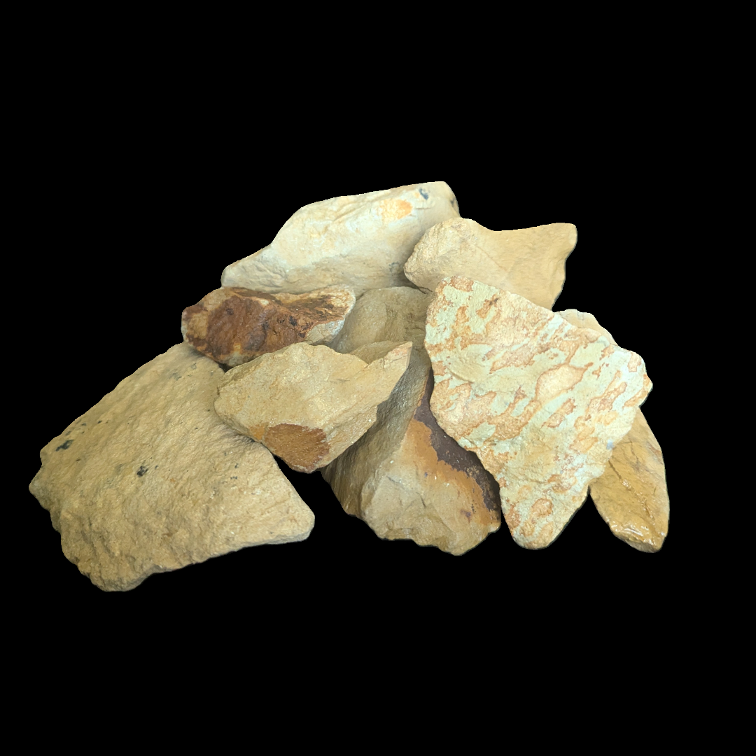 A garden with a tree and rocks on a brick sidewalk