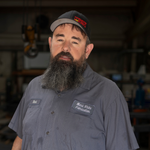 A man with a beard wearing a hat 