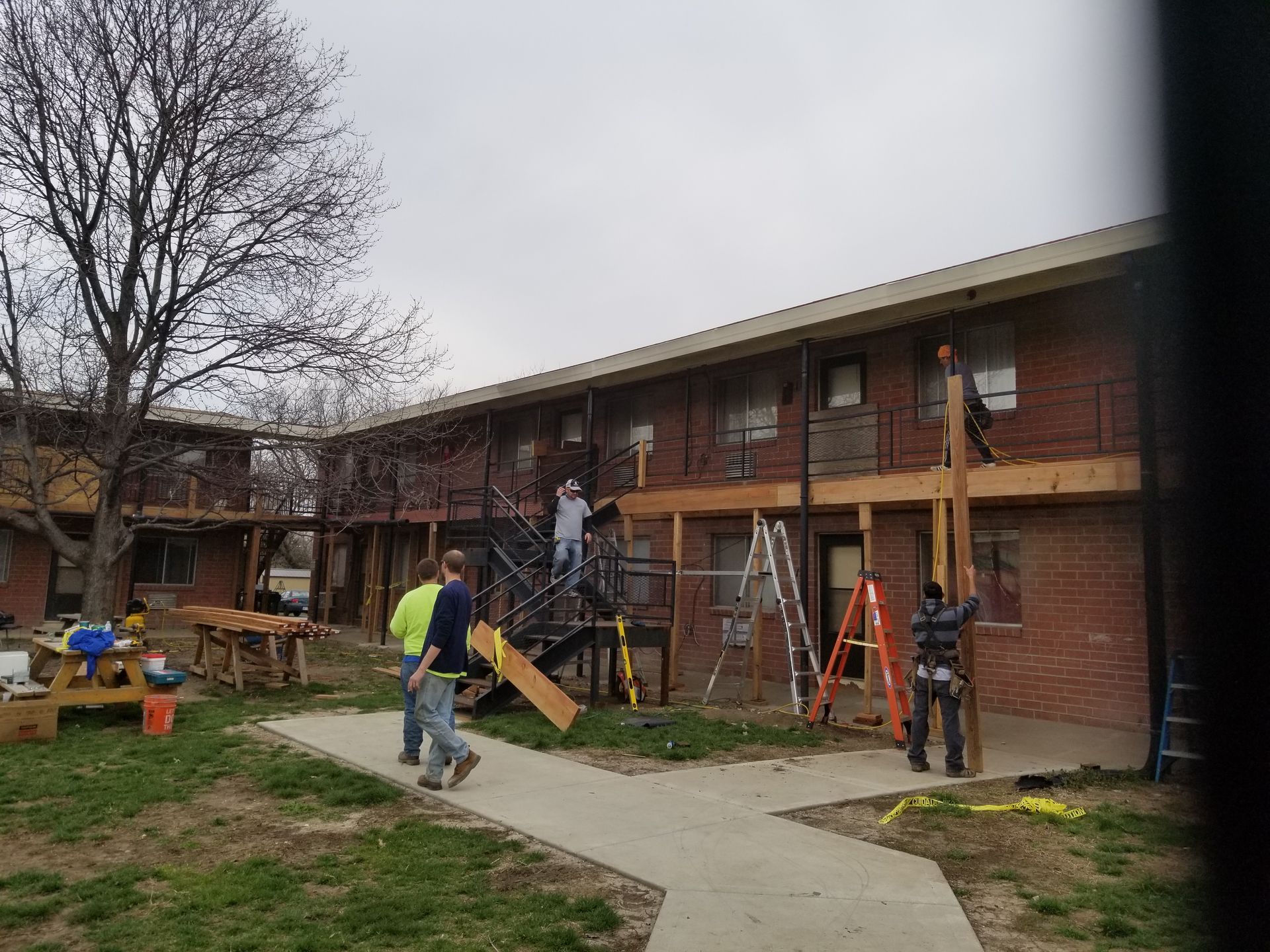 A group of people are working on a brick building