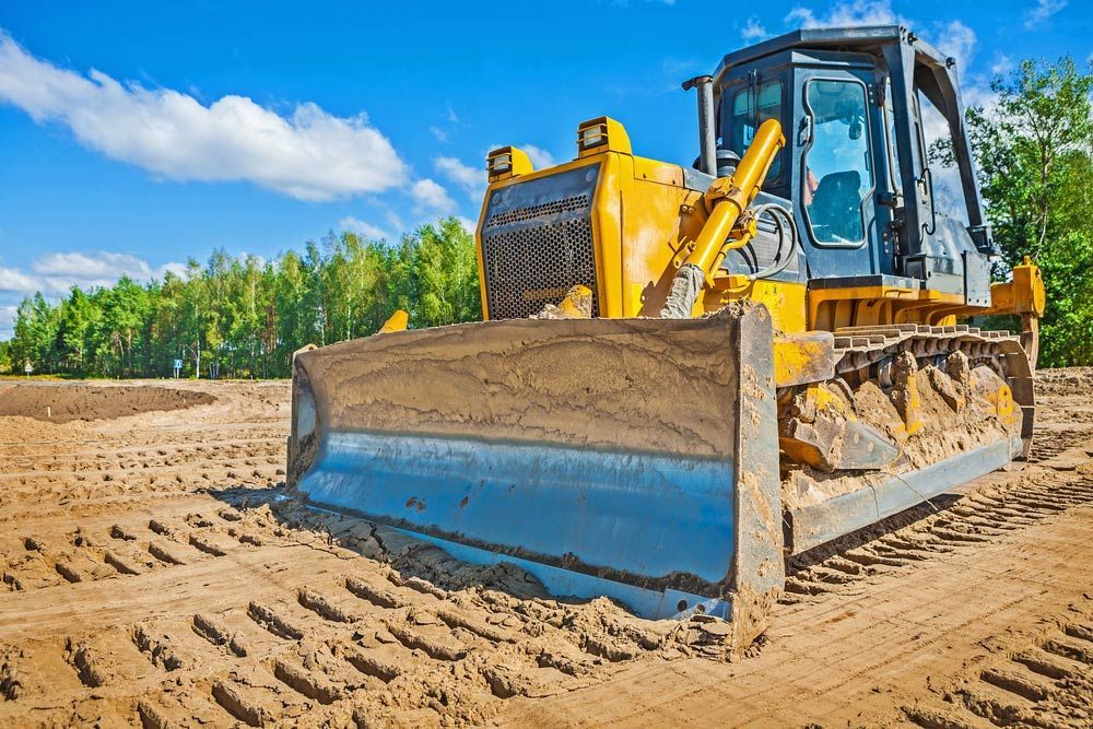 A Bulldozer Is Moving Sand On A Construction Site — Ian Brown Sand Supplies and Tipper Hire In Laurieton, NSW
