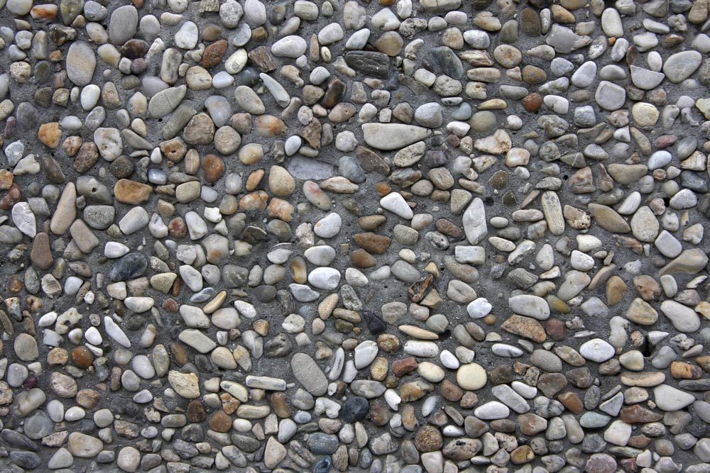 A Pile Of Rocks On A Concrete Surface — Ian Brown Sand Supplies and Tipper Hire In Port Macquarie, NSW