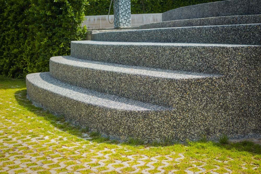 A Set Of Concrete Stairs Leading Up To A Grassy Area — Ian Brown Sand Supplies and Tipper Hire In Port Macquarie, NSW
