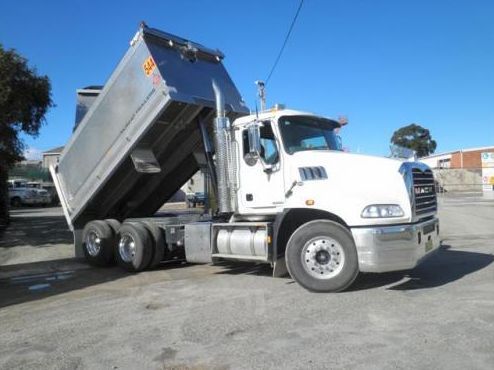A White Truck With a Raised Bed