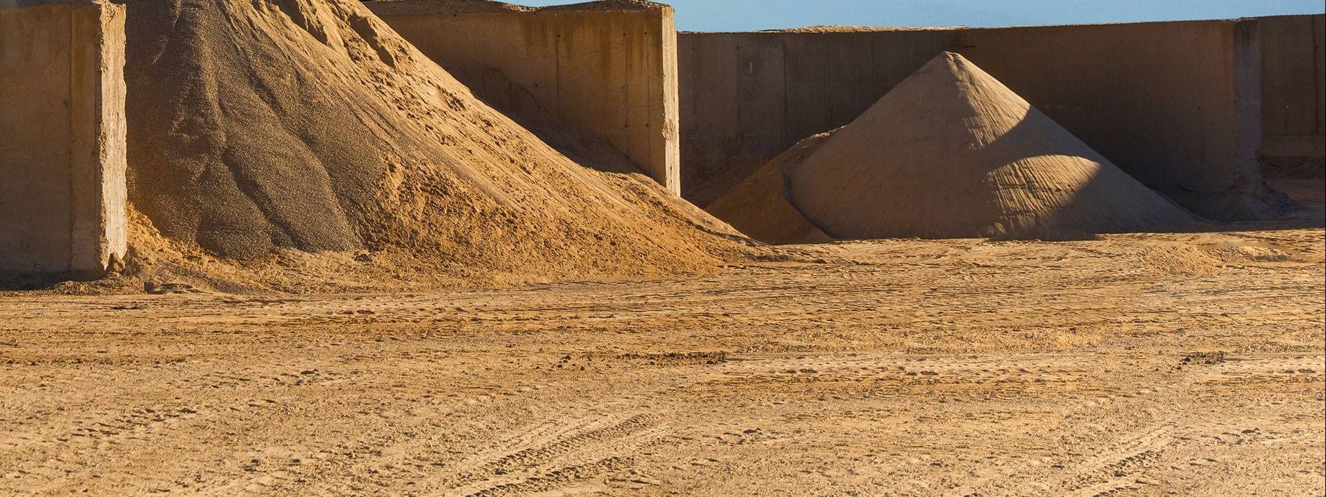 Construction Site With Large Piles of Sand