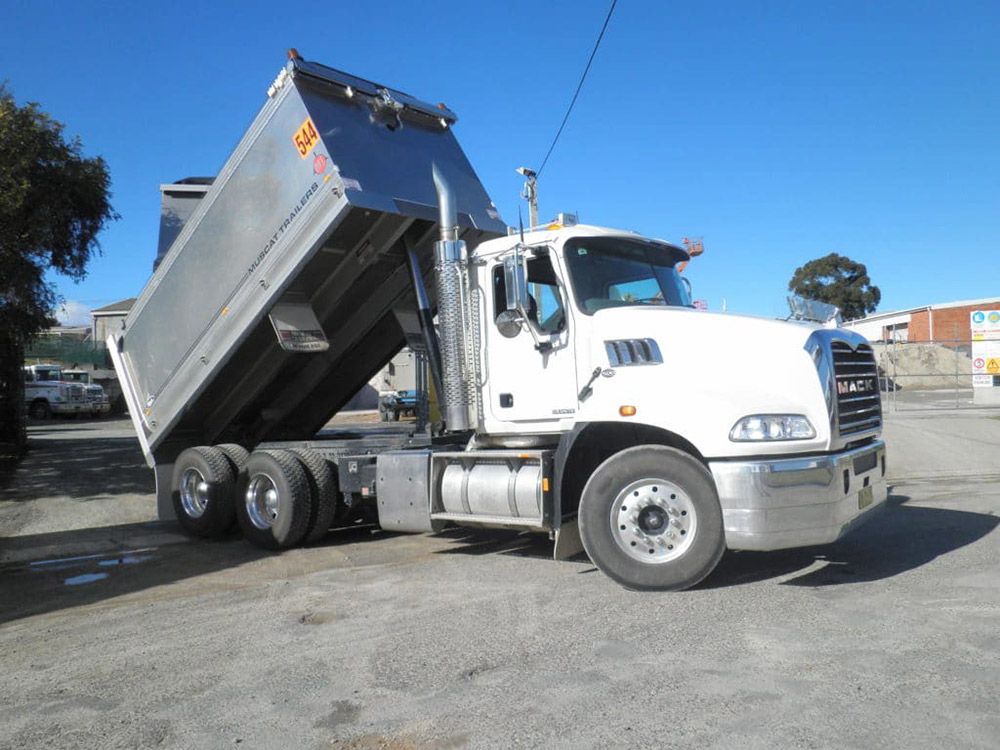 A White Dump Truck Is Parked In A Parking Lot — Ian Brown Sand Supplies and Tipper Hire In Port Macquarie, NSW